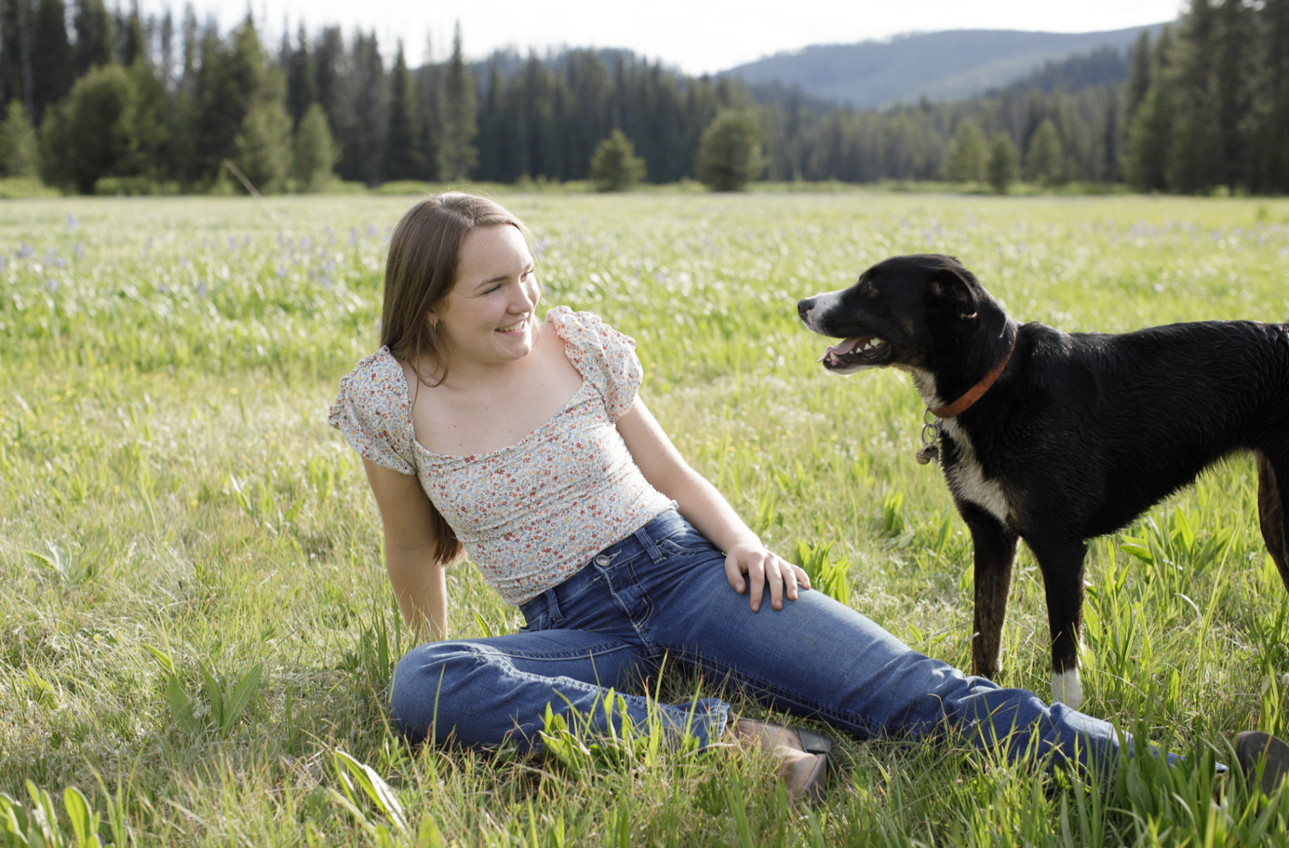 Charlee Unsworth, founder of Camas Rock LLC, in a Montana meadow with her dog